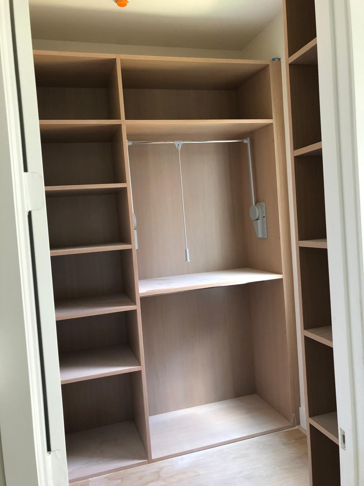 Custom white built-in closet shelving and drawers