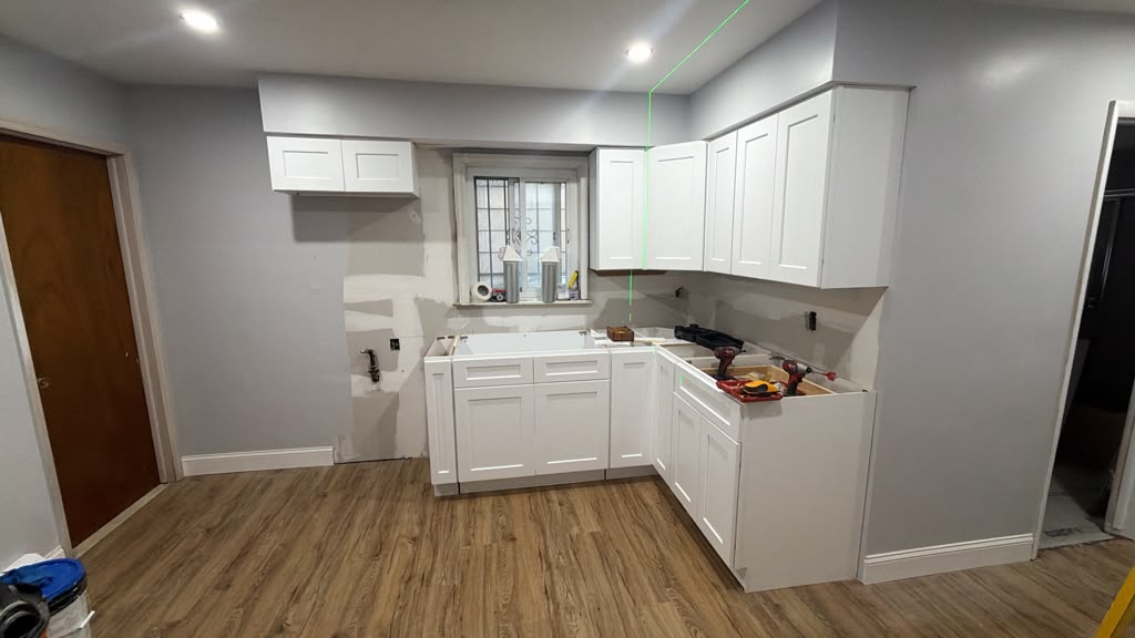 White shaker cabinets and flooring during a Tenafly, New Jersey kitchen remodel