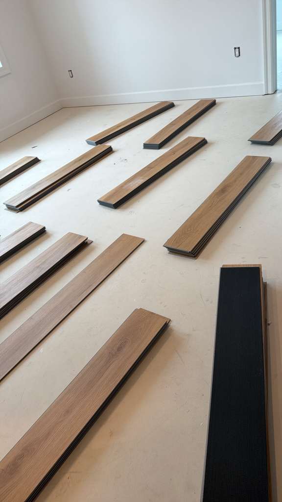 Flooring boards laid out before installation in the Pine Brook condo